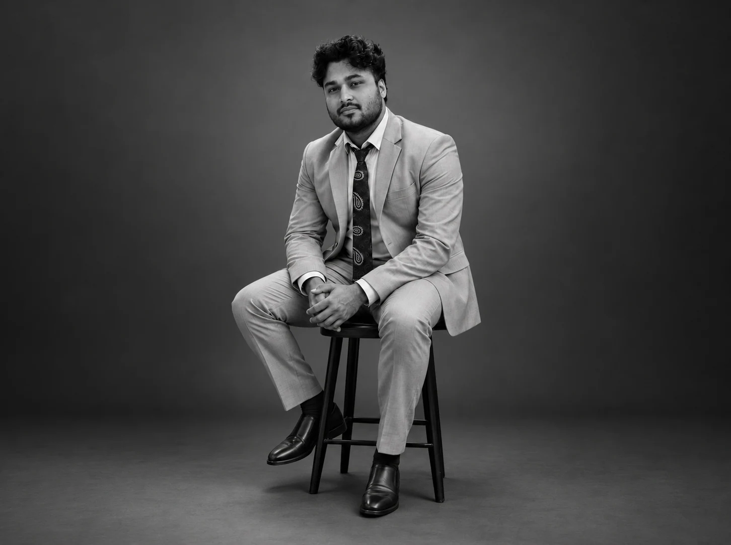 Ankit Maurya seated in a suit